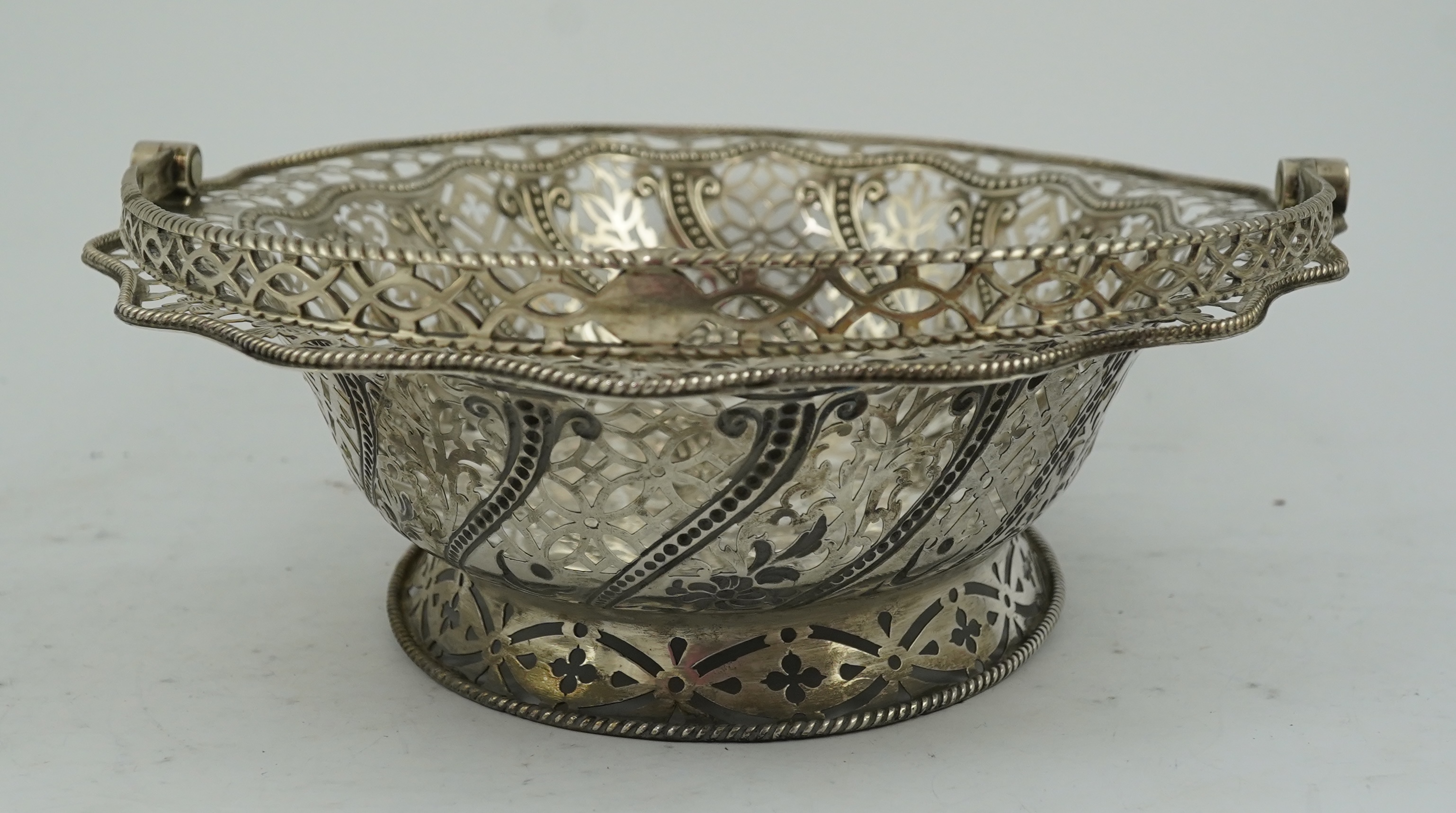 A George III pierced repousse silver cake basket